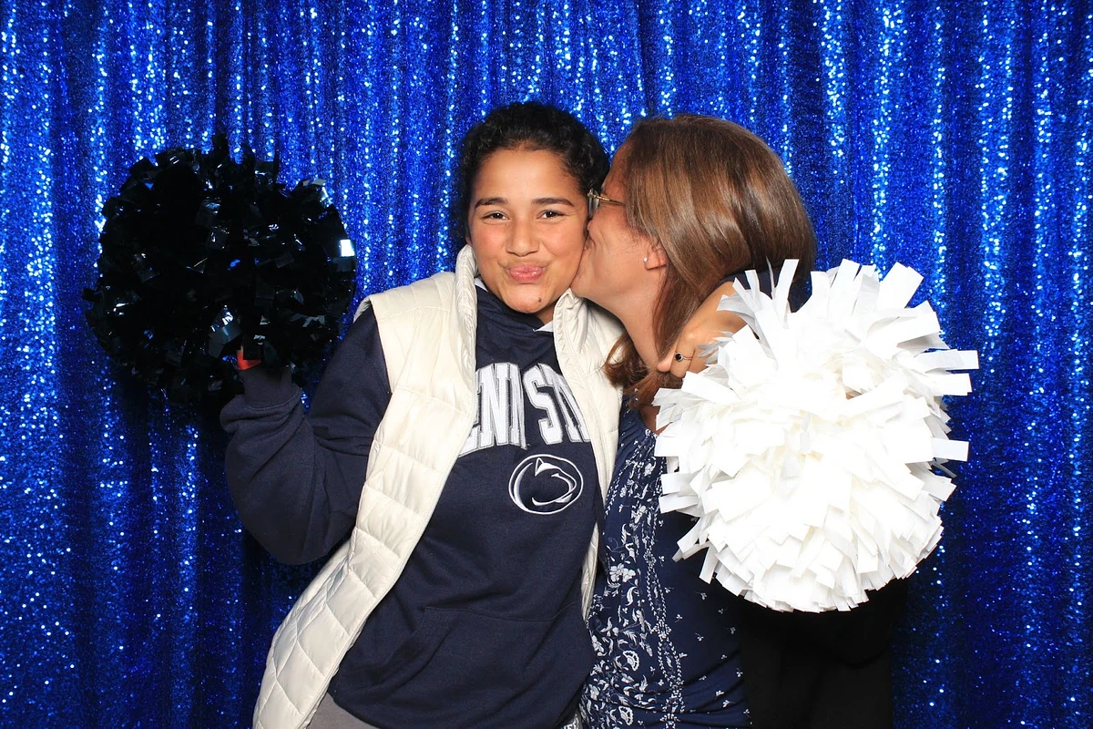 Mother and her student holding pompoms
