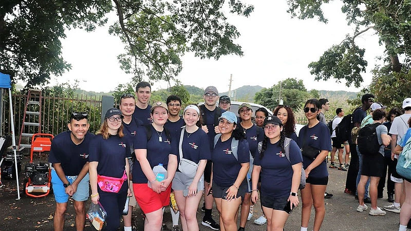 Group of student volunteers pose for camera.