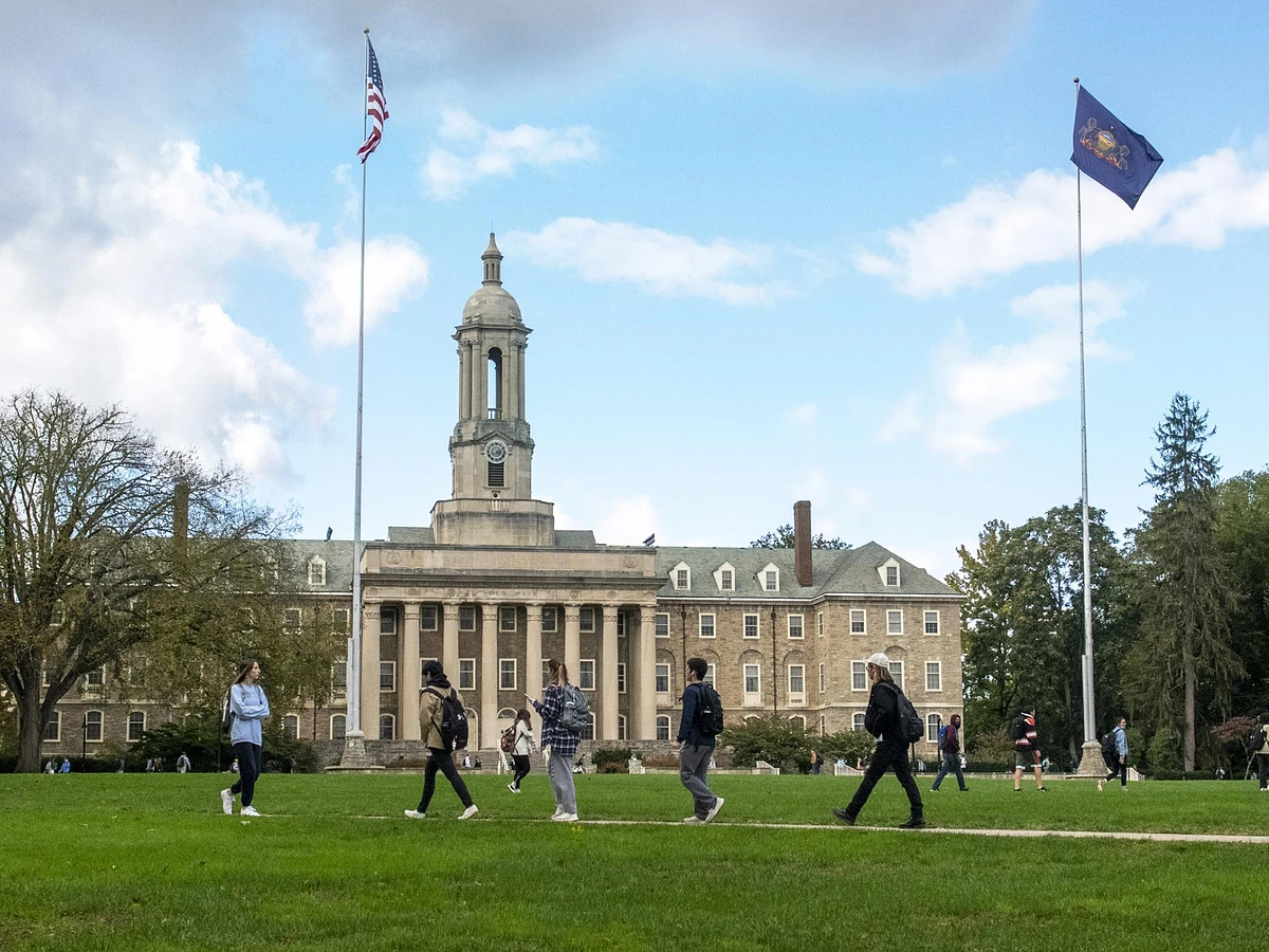 Penn State students walking in front of Old Main. Credit: Patrick Mansell / Penn State. Creative Commons