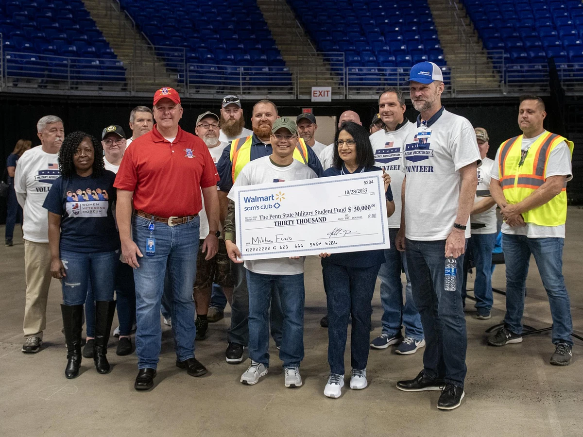 At the 11th annual Military Appreciation Tailgate at the Bryce Jordan Center on Oct. 28, Penn State President Neeli Bendapudi was formally presented with a check for $30,000 from Walmart and Sam’s Club to support military-connected families. Credit: Penn State. All Rights Reserved.